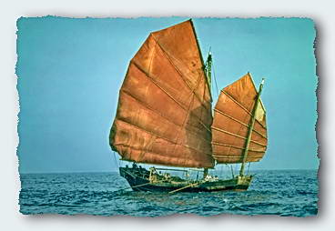 A Chinese Junk being rowed just off Hong Kong