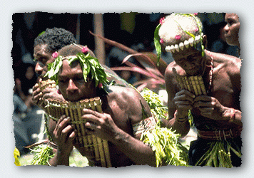 Solomon Island men dance and play the pan pipes at a festival in Honiara. 