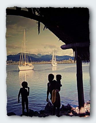 Children pass by us as we talk in the Canoe hut. Moira and another yacht anchored off the village. 