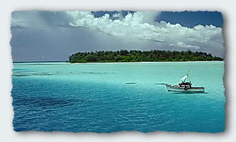 Leo's fishing boat in front of an island on Nothing Atoll 