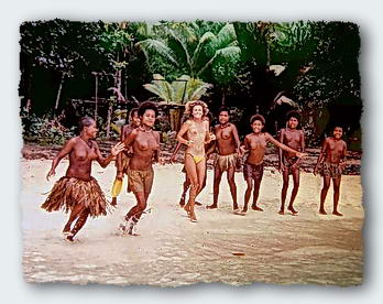 Freddy runs into the water with a group of girls from the village on Labi Island 